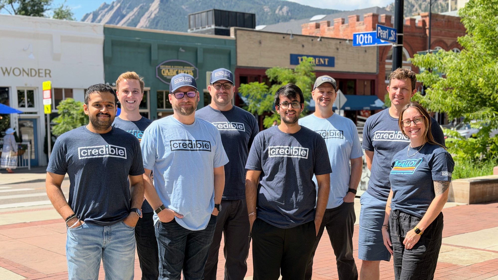 The Credible team on Pearl Street in Boulder, Colorado, with the Flatirons in the background